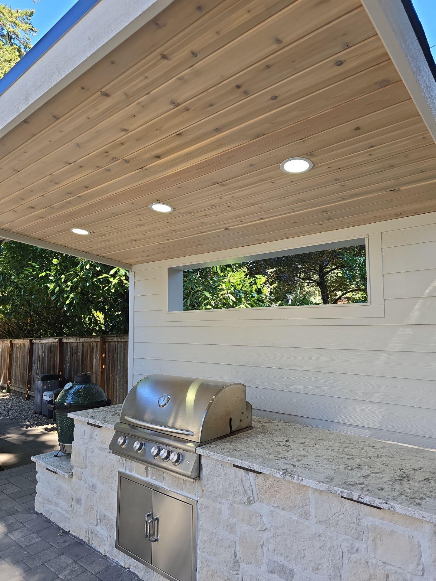 Outdoor lighting installation in Oregon over an outdoor grill patio